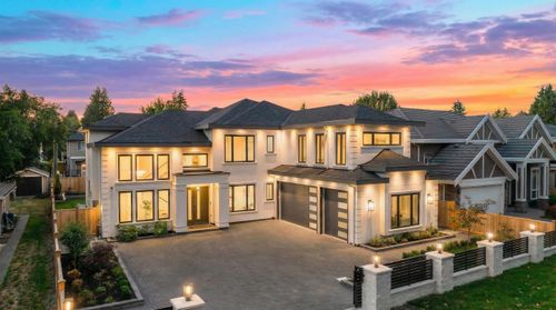 View of front facade with decorative driveway, a shingled roof, and an attached garage | Card Image