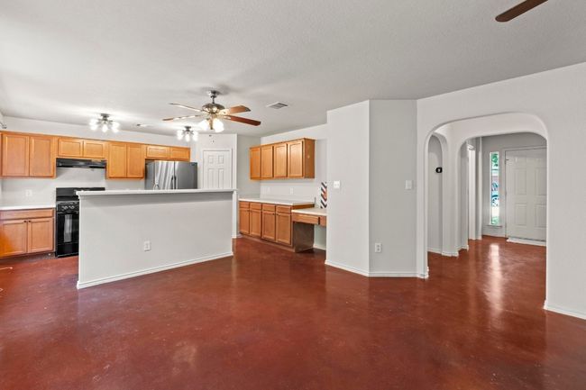 This angle showcases the open/functional layout and the stained concrete flooring throughout the main level. | Image 5