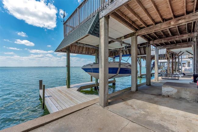 Launch your boat for a day on the bay or cast a line right from your back area, this setup makes it easy to enjoy life by the water. Everything’s right here—boat lift, dock, and plenty of room to fish or relax. | Image 30