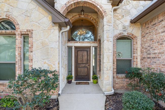 Doorway to property featuring stone siding | Image 6