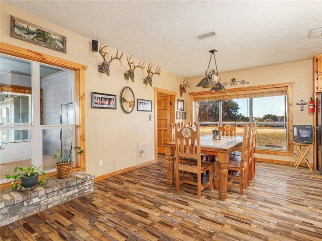 View from living room to dining with windows all around | Image 7