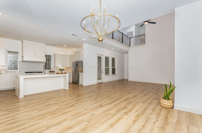 Kitchen featuring appliances with stainless steel finishes, open floor plan, a ceiling fan, tasteful backsplash, and recessed lighting | Image 14