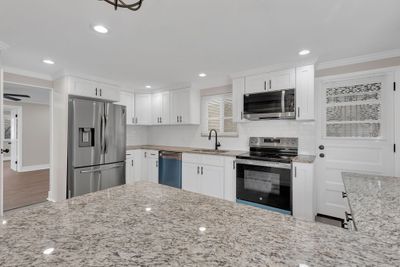 Brand new kitchen open to the dining room. | Image 3