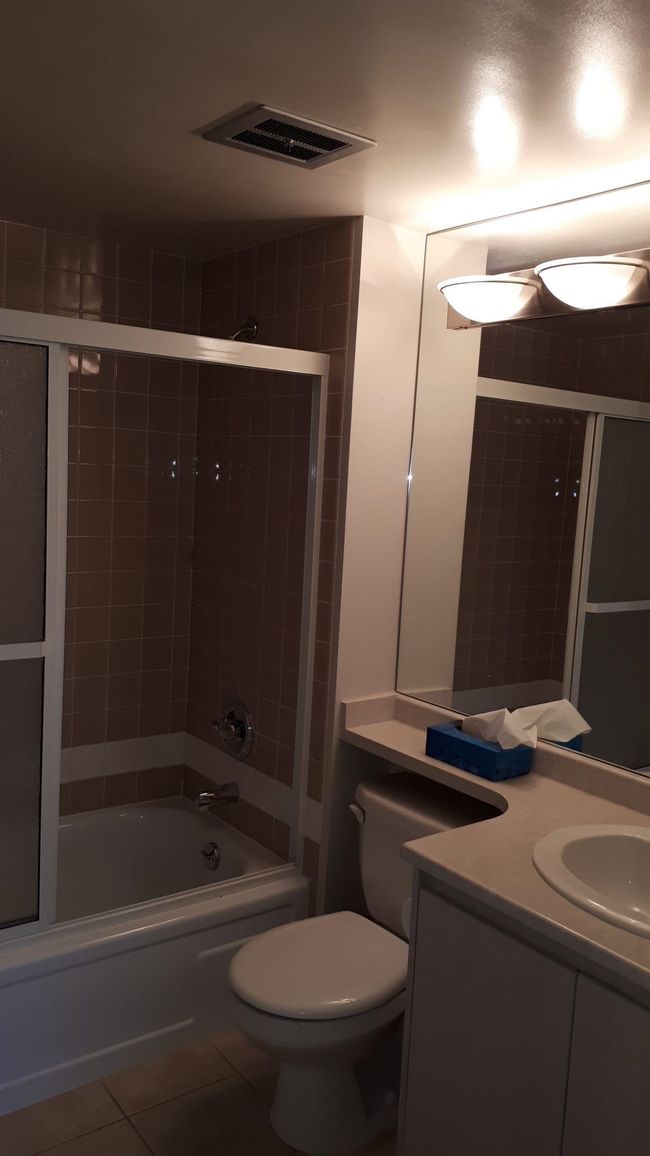 Bathroom with tile patterned floors, visible vents, toilet, shower / bath combination, and vanity | Image 19