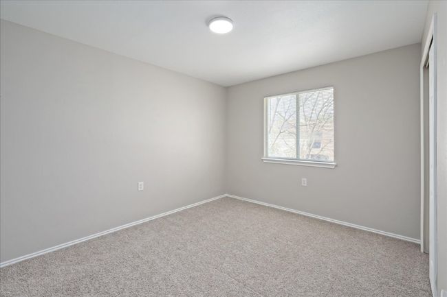 Unfurnished bedroom featuring baseboards and carpet | Image 25