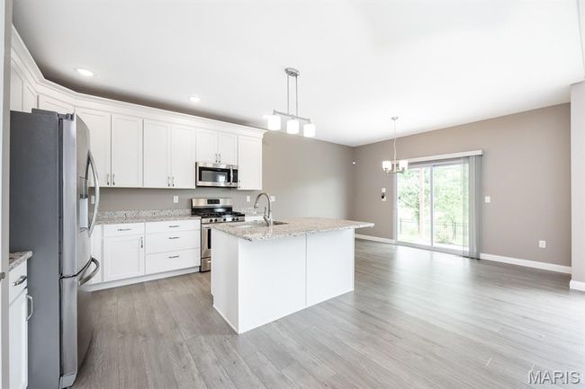 Center Island, stainless appliances and custom cabinetry | Image 10
