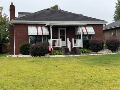 View of front of home featuring a porch and a front lawn | Image 3