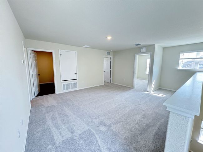 Unfurnished room with light colored carpet and baseboards | Image 12