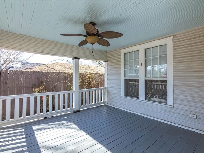Delightful covered porch, perfect for evenings in peace in this tranquil neighborhood! | Image 16