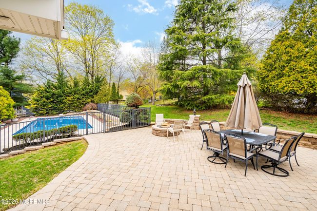 Pool is surrounded by paver patio and fence | Image 48