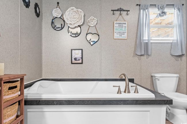 Bathroom with toilet and a bath | Image 18