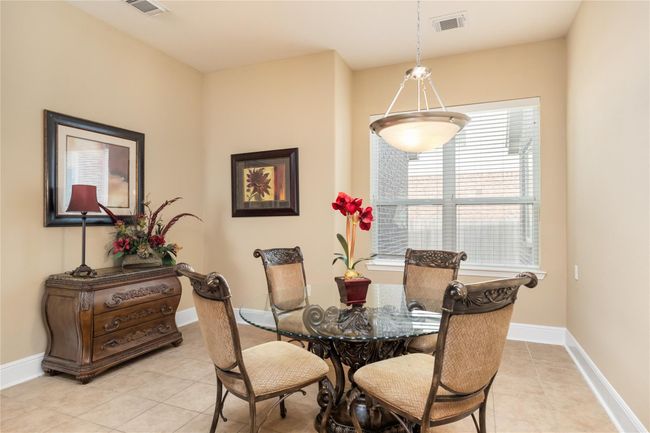 Flooded with natural light and offering plenty of room to spread out, the breakfast room is both inviting and versatile. Tile floors add a clean, polished touch, while the generous layout easily accommodates a buffet table or china cabinet—perfect for casual meals or weekend brunches with family and friends. | Image 11