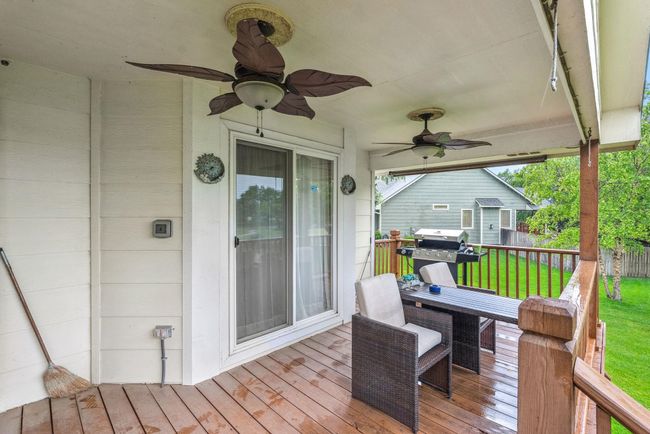 Deck with ceiling fan, a yard, and grilling area | Image 23