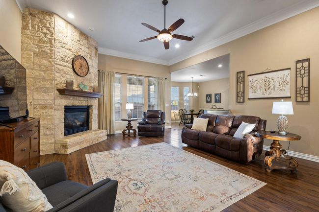 Floor-to-ceiling stone fireplace, beautiful luxury vinyl plank floors. | Image 11