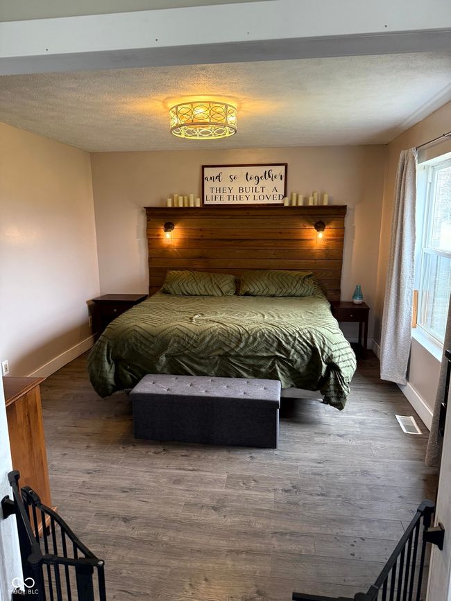 bedroom featuring baseboards and wood finished floors | Image 23