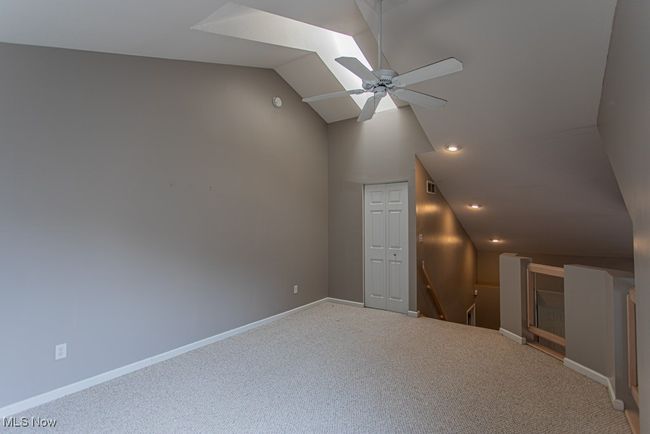 Additional living space with a skylight, lofted ceiling, carpet floors, ceiling fan, and recessed lighting | Image 24