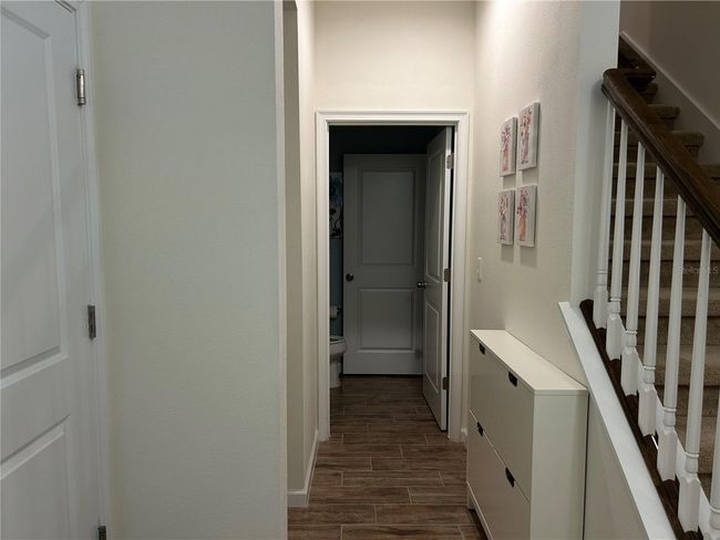 entry with half bath at the end of hallway | Image 4