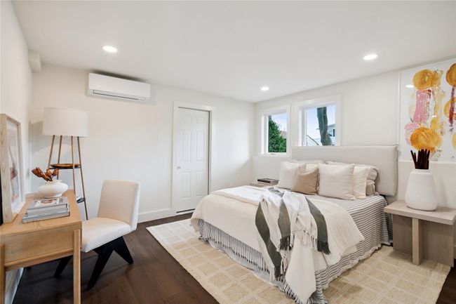 Bedroom featuring an AC wall unit, recessed lighting, and wood finished floors | Image 28