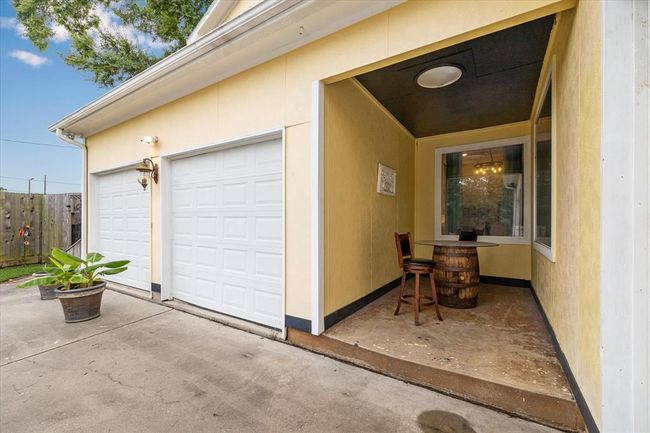 Covered front patio sitting area with sky light | Image 4