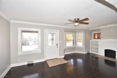 Entryway featuring track lighting, ceiling fan, a healthy amount of sunlight, and dark wood-type flooring | Image 2