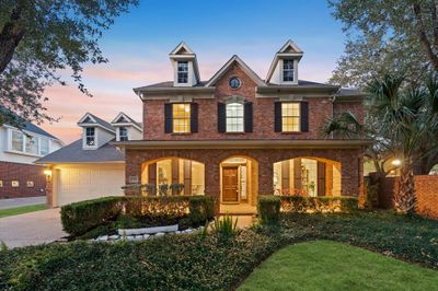 A beautifully landscaped front lawn featuring manicured greenery and vibrant flower beds. A perfect welcome to this elegant home! | Image 2