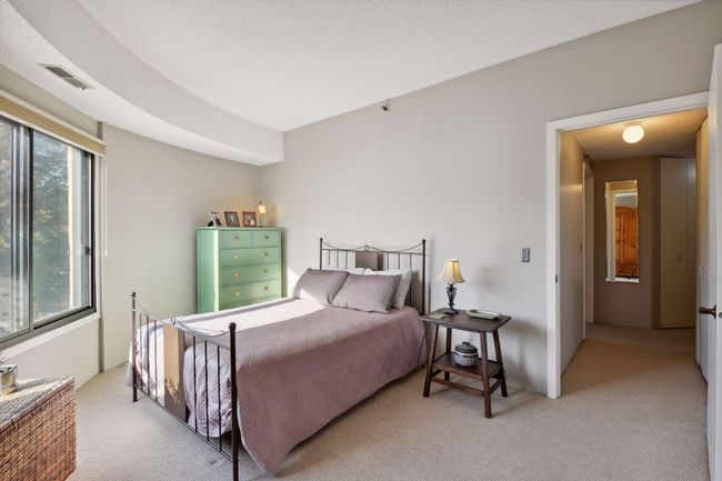 Sunny and serene owner's bedroom with beautiful views and a full wall of closets. | Image 14