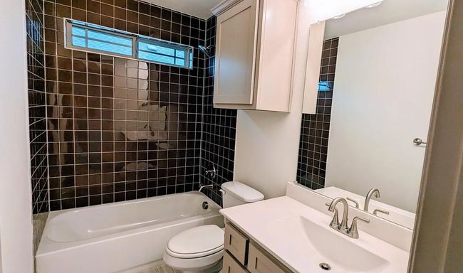 Bathroom with shower / bathing tub combination, vanity, and toilet | Image 7