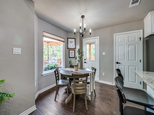 Dining space with a chandelier, baseboards, and dark wood finished floors | Image 8