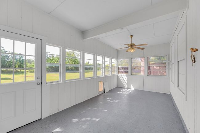 Unfurnished sunroom featuring ceiling fan and french doors | Image 27