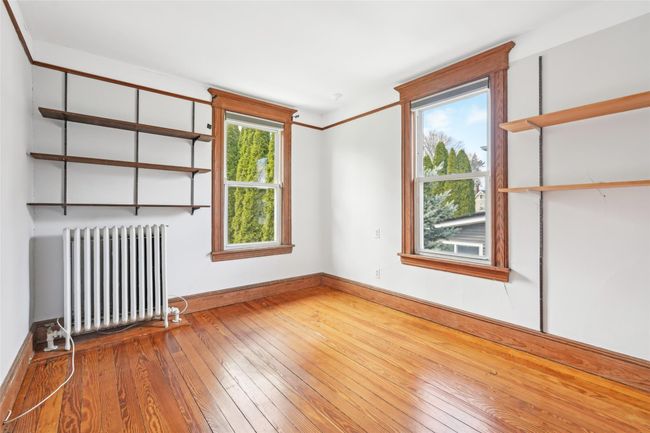 Empty room featuring hardwood / wood-style floors, radiator, and baseboards | Image 14