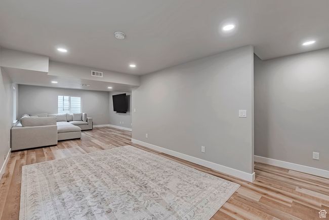 Living room featuring baseboards, light wood-style flooring, and recessed lighting | Image 25