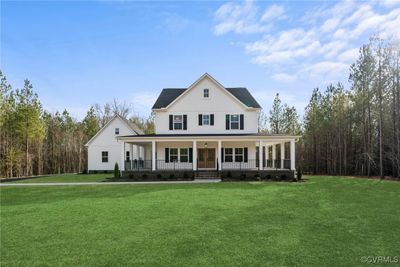 Country-style home featuring a front yard and covered porch | Image 1