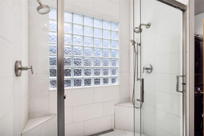 Bathroom featuring a stall shower and healthy amount of natural light | Image 11