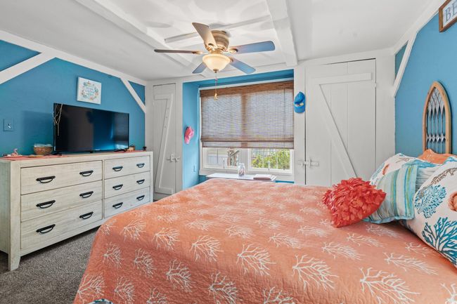 Bedroom with ceiling fan, beamed ceiling, and carpet | Image 17