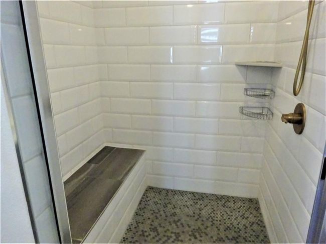 Bathroom featuring a tile shower | Image 15