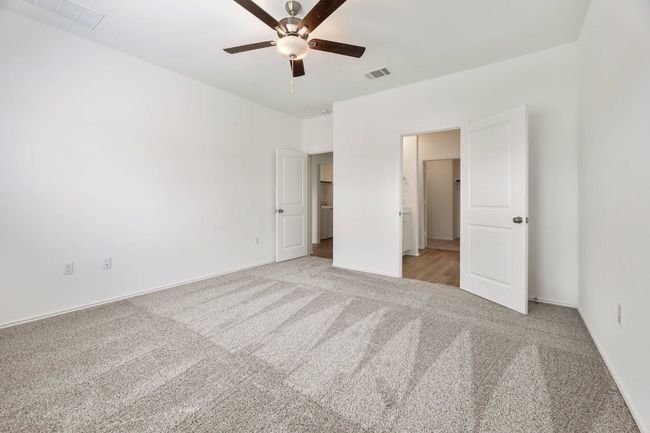 Unfurnished bedroom featuring light colored carpet and a ceiling fan | Image 20