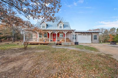 View of front of property featuring a garage and covered porch | Image 2