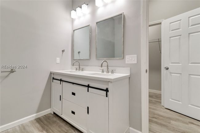 Bathroom featuring double sink vanity and hardwood / wood-style floors | Image 27
