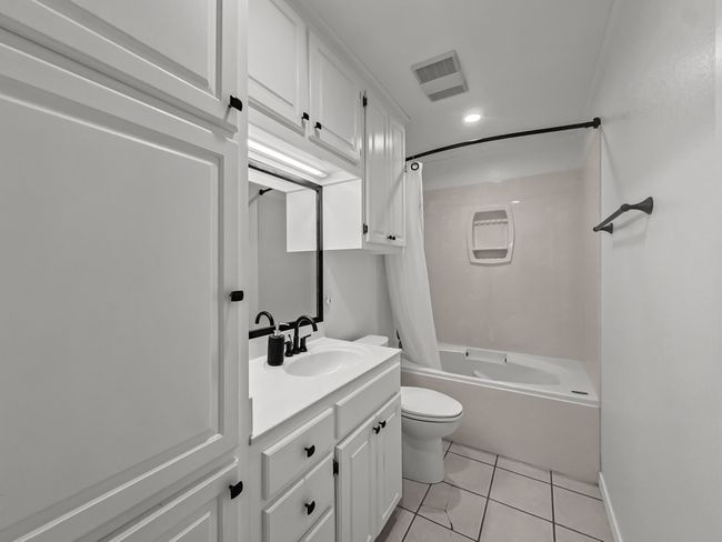 Full bath featuring vanity, bathing tub / shower combination, tile patterned floors, and recessed lighting | Image 12