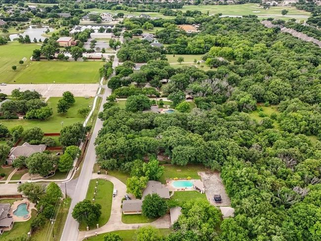 Bird's eye view of a nearby body of water and a pool area | Image 8