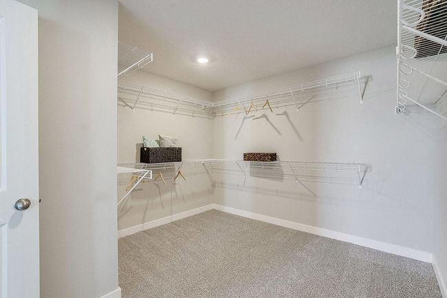 Our LARGEST primary suite walk-in closet! Time to go shopping! Photo of model home, color and options will vary. | Image 15