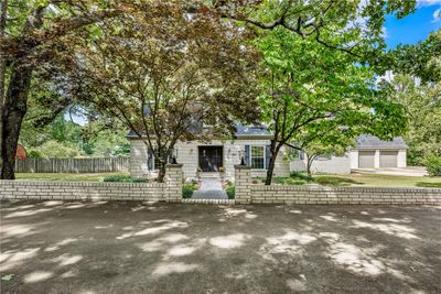 View of the welcoming entry from the 2-lane-wide circle driveway | Image 1