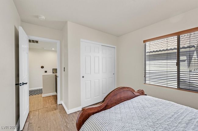 Bedroom with a closet, baseboards, visible vents, and light wood-style flooring | Image 22