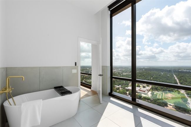 Full bathroom featuring a soaking tub and tile patterned floors | Image 20