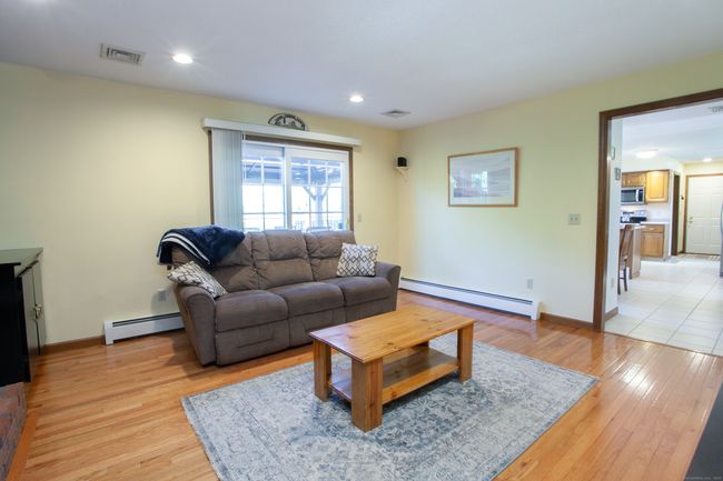 Family room right off the kitchen with beautiful hardwood floors. | Image 9