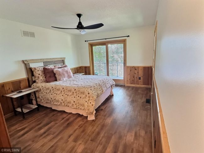 Your own little sanctuary, the primary bedroom features a private deck showcasing gorgeous Cedar Lake views. | Image 18