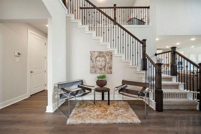 Stairs featuring wood finished floors, a high ceiling, recessed lighting, and arched walkways | Image 11