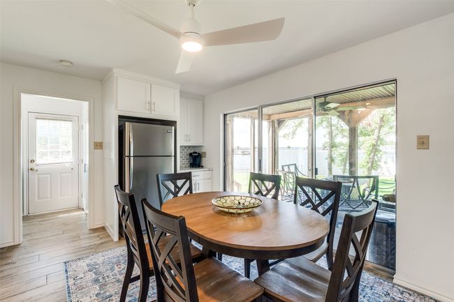 Dining room featuring ceiling fan and light wood-style flooring | Image 10