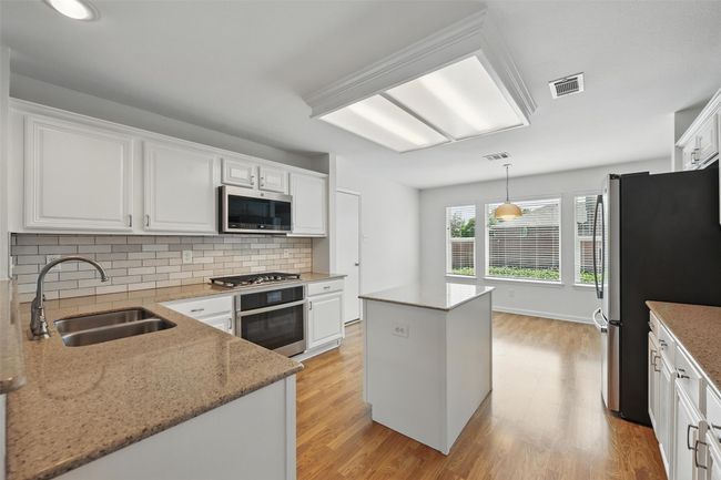 The kitchen has been refreshed with paint & granite countertops. | Image 12