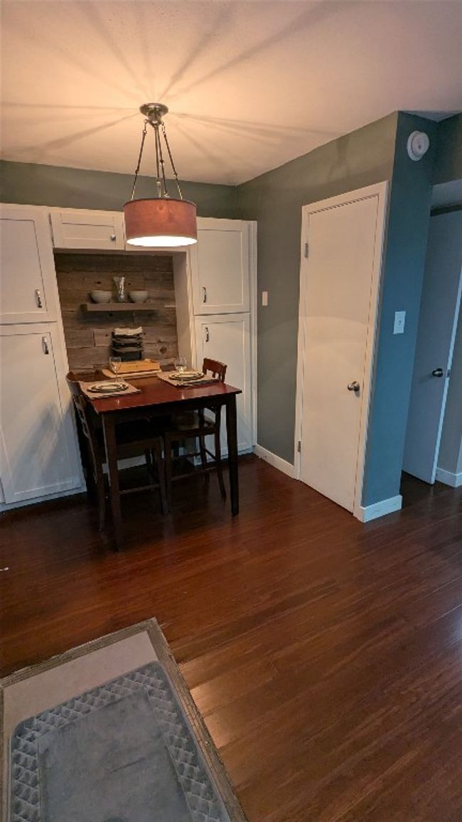 Dining room with dark wood finished floors and baseboards | Image 13